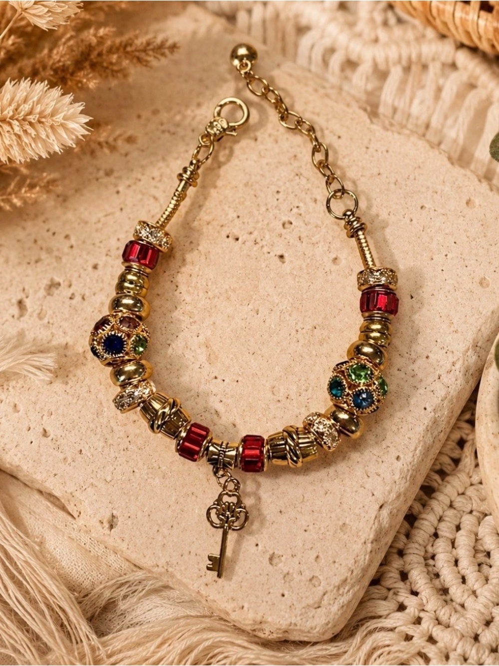 Handmade Gold Beaded Bracelet with Red Accents and Key Charm